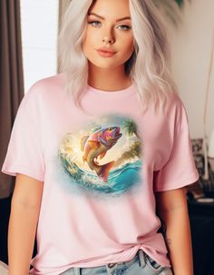 a woman with white hair wearing a pink t - shirt that has an image of a fish on it