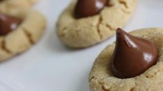 some cookies with chocolate on top are sitting on a plate