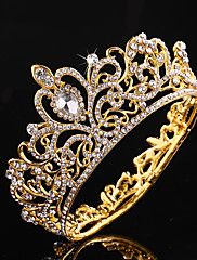 a gold tiara with white stones on the top and bottom, in front of a black background