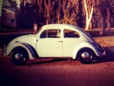 an old car is parked on the side of the road