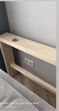 a bed with a wooden shelf next to it