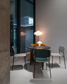 a table with two chairs and a lamp on it