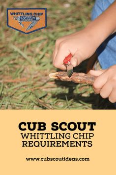 a child is holding a piece of wood with the words cub scout written on it