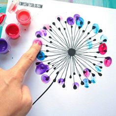 someone is painting a dandelion with watercolors on paper and then using markers