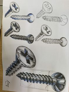 a drawing of buttons and screws on a piece of paper