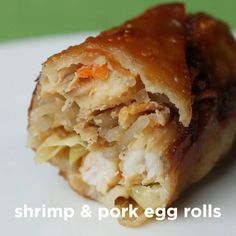 a close up of food on a plate with the words shrimp & pork egg rolls