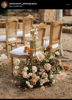 the chairs are lined up with flowers on them