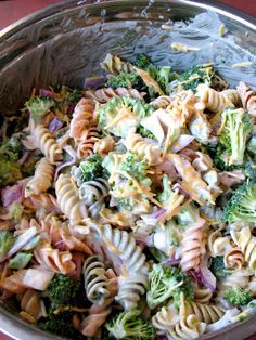 a bowl filled with pasta and broccoli on top of a table