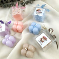 several small soaps are sitting on a white sheet