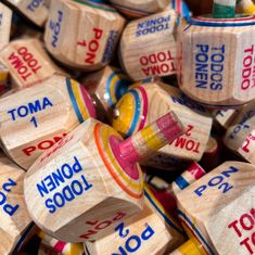 many wooden dices are stacked on top of each other with words written on them