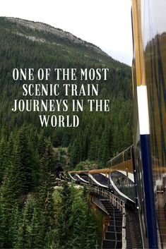 a train traveling down tracks next to a forest covered hillside with the words, one of the most scenic train journey in the world