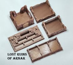 four wooden trays with different designs on them and the words lost ruins of arnark