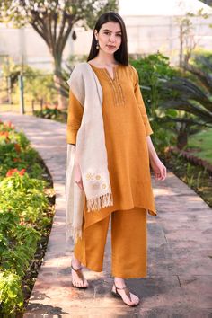 Mustard yellow short tunic with embroidered yoke detail. 
Components: 1
Fabric: 100% Linen
Neckline: Notched
Sleeve Length: Three quarter
Color: Yellow
Embroidered
Note: Pant and stole worn by the model is not for sale - Aza Fashions Short Tunic, Tunics Online, Buy Linen, Yellow Short, Embroidered Tunic, Yellow Shorts, Womens Tunics, Mustard Yellow, Aza Fashion