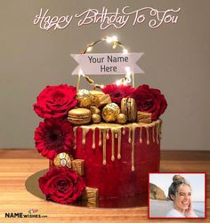 a red and gold birthday cake with chocolates, roses and candies on top