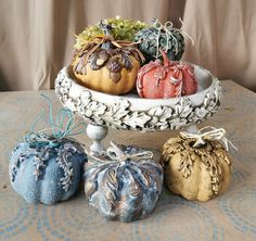 three decorative pumpkins sitting on top of a table