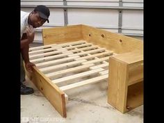 a man is working on a bed frame