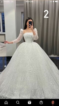 a woman taking a selfie in a wedding dress with her hand on her hip