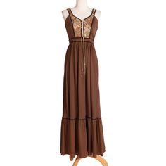 Flowy brown sun dress from the 70s with ornate floral patterned bust. Includes cream lace-up strings in center and tie strings around waist.  Measurements Bust: 34" Waist: 26" Length: 55" Sweep: 120" Condition: Great; tiny stain on front (See images) Brown Hippie Maxi Dress For Festival, Brown Lined Maxi Dress For Summer, Vintage Brown Dress For Vacation, Hippie Brown Maxi Dress For Summer, Spring Brown Lined Maxi Dress, Vintage Brown Maxi Dress For Beach, Summer Brown Lined Maxi Dress, Brown Fitted Hippie Dress, Hippie Sleeveless Brown Dress