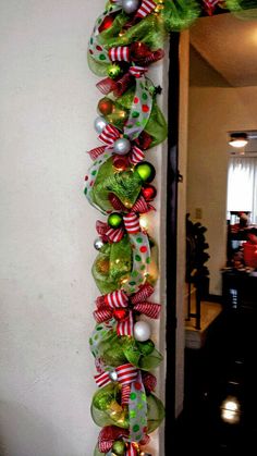 a christmas wreath hanging on the side of a wall