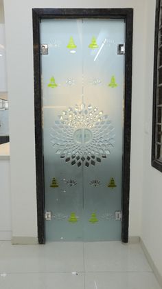 an open glass door with decorative designs on it