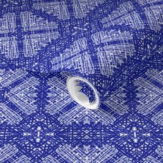 a blue and white fabric with an intricate design on it's back end,