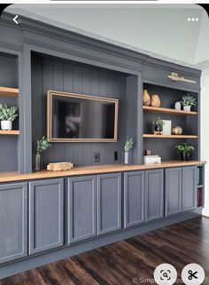 an entertainment center with built - in cabinets and a flat screen tv mounted on the wall