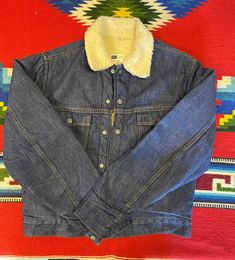 "Vintage 70's Sears Roebucks denim sherpa lining jacket size 36R. Two chest pockets, snap buttons closure, sherpa lining. Nice jacket in good use condition made by Sears, Roebuck and Co. Please, check carefully the measurements, photos and description of the article before buying it, we do not accept changes or returns. Measuraments lying face down from outside: 19\" Across chest underarm to underarm. 17\" Shoulder seam to seam. 25\" Sleeve length from shoulder to cuff. 23\" Long, front middle t Western Style Dark Wash Outerwear With Pockets, Western Style Cotton Winter Outerwear, Western Style Winter Outerwear With Snap Buttons, Winter Outerwear With Pockets For Rodeo, Winter Rodeo Outerwear With Pockets, Western Denim Outerwear With Pockets, Denim Jacket With Pockets For Rodeo, Western Style Medium Wash Cotton Outerwear, Western-style Medium Wash Cotton Outerwear