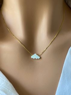 This delicate white opal cloud necklace is the perfect piece to add a touch of pure elegance to your look, this necklace is crafted from lab created white opal stones, creating a stunning effect as it reflects light. With intricate detailing and minimalist design, this necklace is sure to elevate your style and make you stand out from the crowd. Perfect for everyday wear, this necklace will become an indispensable part of your accessory collection - and it doesn't even have to be taken off! It is a perfect gift for yourself or your friends and family. Pendant: Lab Opal 7.3x12mm Chain: 18 inches 925 Sterling Silver Box Chain or Gold Plated Chain Over Sterling Silver Necklace length is fully adjustable by holding down the sliding bead and pulling on the chain. Wear it as a choker or longer b White Opal Necklace With Delicate Chain, Cloud Necklace, Pure Elegance, Necklace White, October Birthstone, Pendant Gold, Opal Pendants, Opal Necklace, October Birth Stone