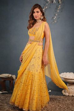 Sunshine yellow pre-draped lehenga saree in georgette, net and chiffon base with zari, beads, sequins and mukaish embroidery. Comes with a padded blouse and a belt.
Components: 3
Pattern: Embroidered
Type Of Work: Zari, Beads, Sequins, Mukaish
Neckline: Square Neck
Sleeve Type: Sleeveless
Fabric: Georgette, Net, Chiffon
Color: Yellow
Other Details: 
Attached lining
Lehenga length : 44 inches
Closure :
Lehenga : Side zip
Blouse - Back tie-up
Occasion: Destination Wedding - Aza Fashions Mukaish Embroidery, Drape Lehenga, Haldi Ceremony Outfit, Haldi Outfits, Haldi Outfit, Bridal Sarees South Indian, Indian Outfits Lehenga, Yellow Lehenga, Blue Lehenga