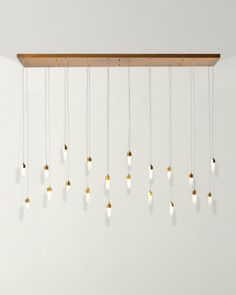 a bunch of lights that are hanging from a light fixture in a room with white walls