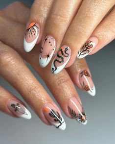 Embrace a boho-chic vibe with intricate tribal-inspired patterns in black and orange on a nude and white base. The detailed designs, including snakes, moons, and cacti, create a striking contrast against the soft background. The elongated oval shape and glossy finish complete the look, perfect for those who love unique, artistic nail art.@bees.knees.nails Bees Nails, Inspiration Nails, Boho Nails