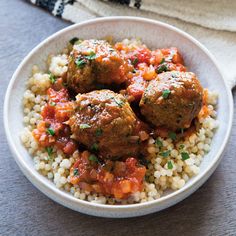 meatballs and rice in a bowl on a table