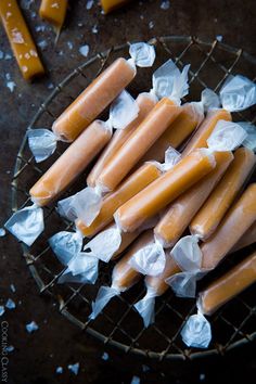 several pieces of food sitting on top of a wire rack with plastic wrappers around them