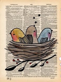 three birds sitting in a nest on top of an open book