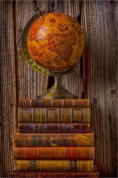 an old globe sitting on top of some books