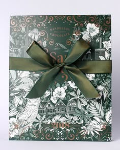 a gift card with a green bow tied around the ribbon on it's side