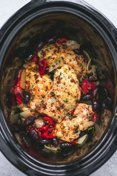 chicken, olives and peppers in an instant pot with the lid open to show what's inside