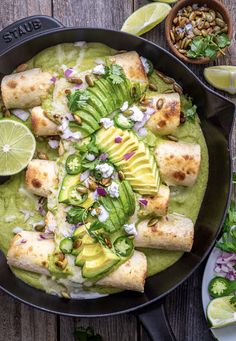 a skillet filled with food and garnished with avocado, sour cream