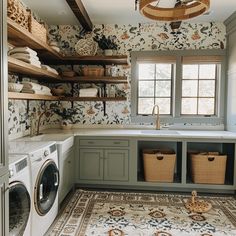 a washer and dryer in a room with floral wallpaper on the walls