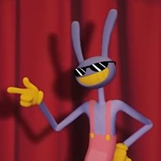 a cartoon character standing in front of a red curtain and pointing to the side with one hand