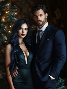 a man and woman standing next to each other in front of a christmas tree with lights