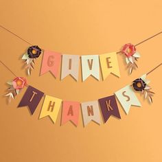 a banner that says give thanks with flowers on it