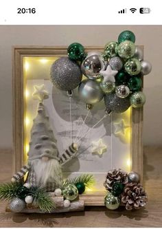 an image of christmas decorations on display in a frame with lights and ornaments around it