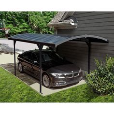 a car is parked in front of a house with a carport attached to it