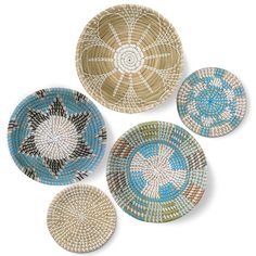 four woven plates with different designs on them