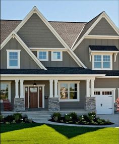 a large house with two garages and three windows