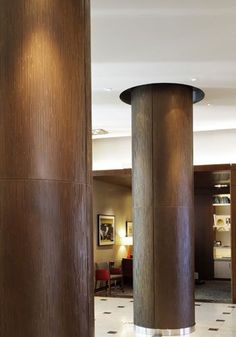 two tall wooden pillars in the middle of a lobby