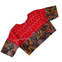 Add a touch of modern elegance to your wardrobe with this Red ikat cotton Blouse. The Pen Kalamkari Elephant border adds an exquisite detail, while the buttons on the back and sleeve edges provide a stylish twist. This blouse effortlessly captures a modish appeal that will elevate any outfit. Item : Blouse  material : Handloom  cotton Ikkat Size fits 36/42 ( Margins Included) Colour : Red Sleeve length :  10.5 inches Back Neck : High Neck Front Neck : 6.5 inches - U Neck Padding : No Lining : Ye Long Sleeve Cotton Blouse With Kalamkari Print, Long Sleeve Cotton Ikat Print Blouse, Red Long Sleeve Blouse With Printed Motifs, Traditional Red Block Print Top, Traditional Long Sleeve Tops With Ikat Print, Cotton Tops With Motifs For Navratri, Red Cotton Silk Blouse Piece With Kalamkari Print, Fitted Ikat Print Blouse Piece, Traditional Long Sleeve Ikat Print Top