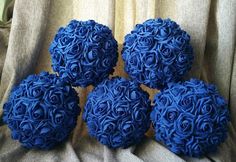 four blue flowers sitting on top of a chair