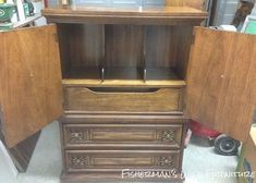 an old wooden cabinet with two doors and drawers on the bottom shelf, next to other items